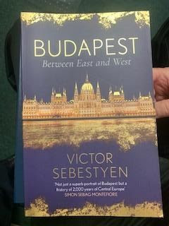 Book cover of "Budapest" by Victor Sebestyen. Purple book with shiny gold buildings.